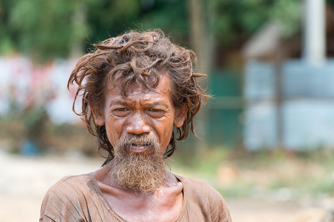 Very strange person walikng barefoot along the highway. Kingdom of Cambodia, Indochina, South East Asia