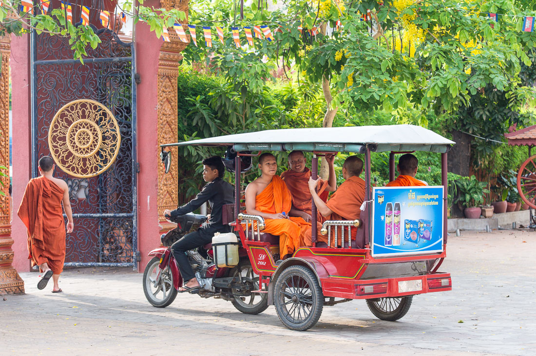 Buddhist monks getting a ride on a moto taxi, Ounalom pagoda. Phnom Penh, Kingdom of Cambodia, Indochina, South East Asia