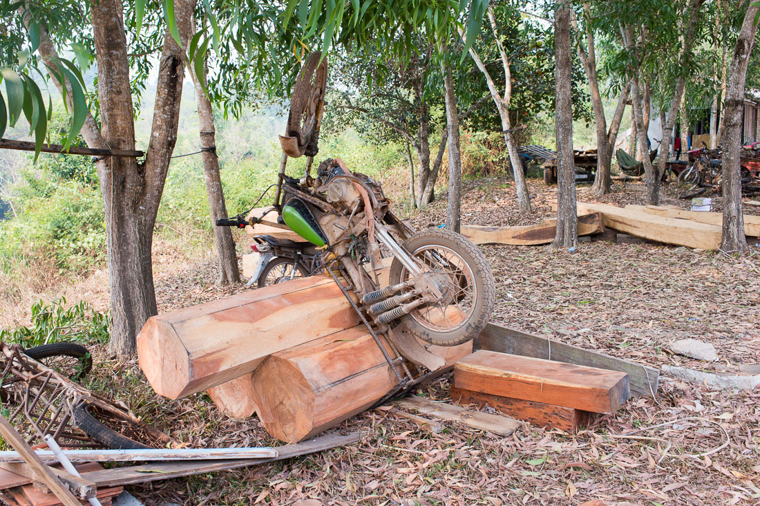 A custom made motorcycle designed to transport heavy timber illegally cut deep inside the Seima protected forest, (the tree logs are close to 2,000 pounds). Mondulkiri province, Kingdom of Cambodia, Indochina, South East Asia