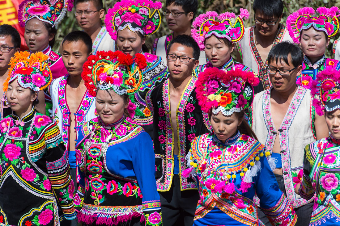 Boys and girls from the Yi ethnic minority people, in traditional colorful costume, performing at the annual festival in Zhi Ju village, Yong Ren County, Yunnan Province, China, Asia. Nikon D4, 70-200mm, f/2.8, VR II