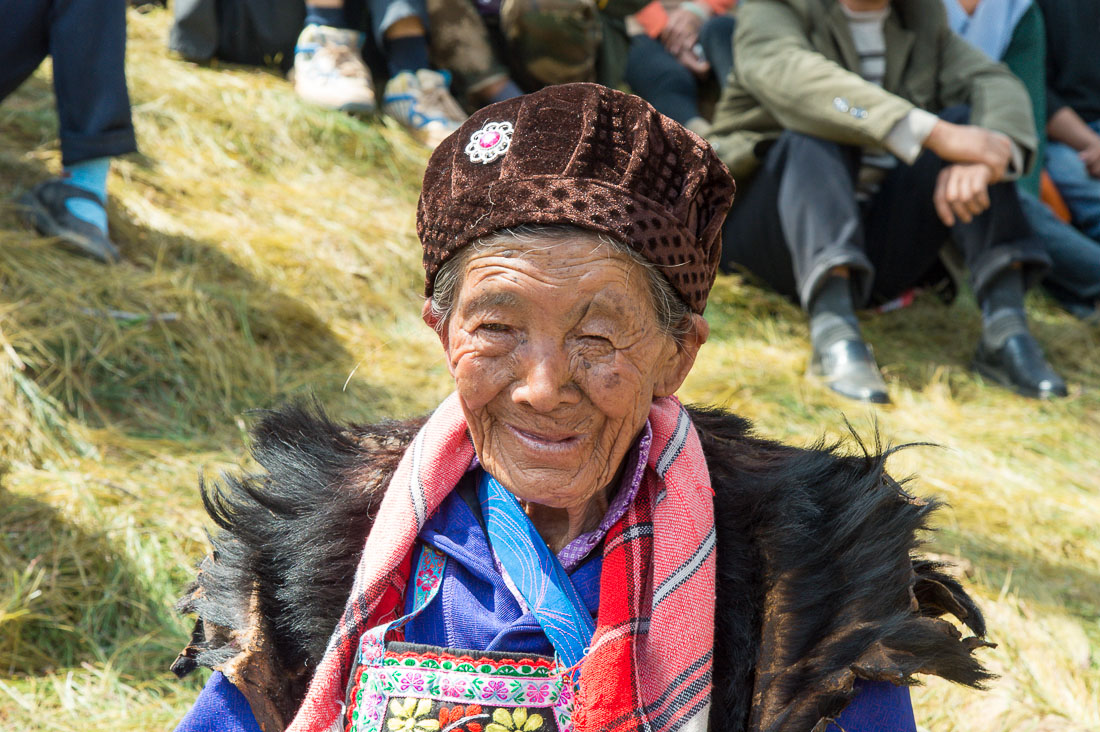 An old woman from the Yi ethnic minority people, wearing the traditional costume at the annual festival in Zhi Ju village. Yong Ren County, Yunnan Province, China, Asia. Nikon D4, 24-120mm, f/4.0, VR