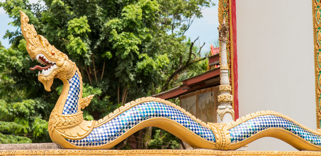 Bhuddist sacred figure, the snake, Naca, at the entrance of the pagoda, Vientiane province. Lao PDR, Laos, Indochina, South East Asia