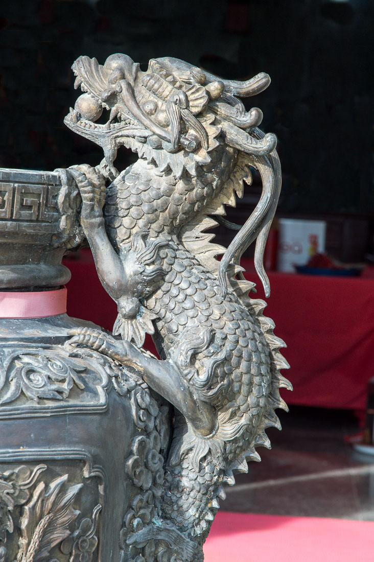A dragon on a bronze ceremonial vase at the entrance of the Chinese Wat Horkang, Vientiane, Lao PDR, Indochina, South East Asia.