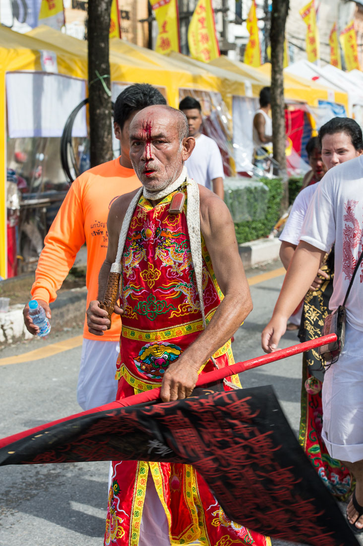 Psychic medium follower of the Bang New Shrine, bleeding from a self inflicted injury on his forehead, during a street procession of the annual Chinese vegetarian festival. Phuket, Kingdom of Thailand, Indochina, South East Asia