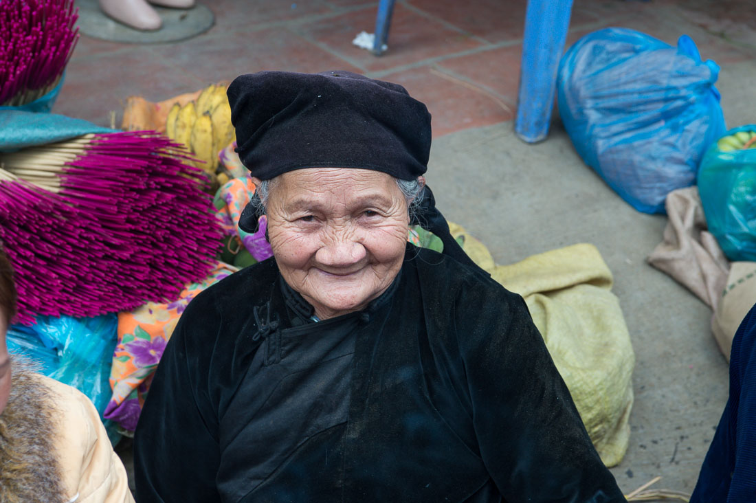 An old woman from the Nung people ethnic minority, wearing traditonal clothes. Viet Nam, Indochina, South East Asia.