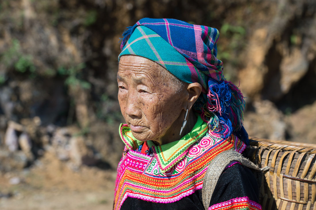 Old woman from the country side, belonging to Red Hmong people ethnic minority, wearing traditional costume, Ha Giang province. Viet Nam, Indochina, South East Asia.