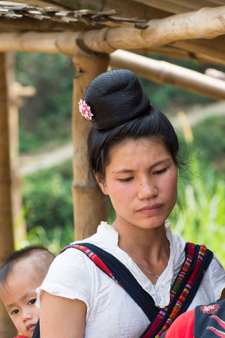 Woman from the Black Tai people ethnic minority with the traditional chignon hairdo, a detail showing she is married, Lai Chau province. Viet Nam, Indochina, South East Asia.