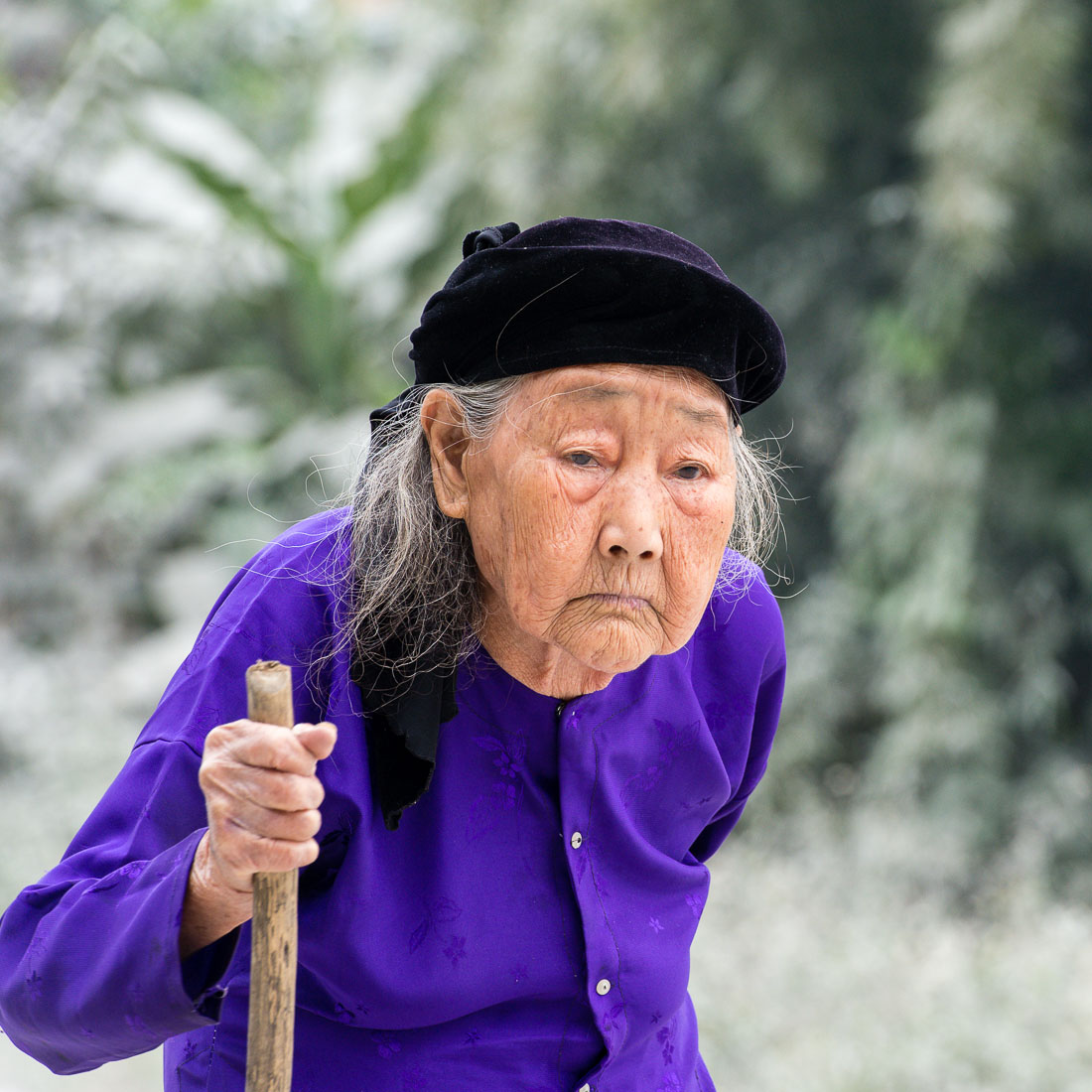 A very old woman from the Nung people ethnic minority group, wearing traditional clothes. Lang Son Province, Viet Nam, Indochina, South East Asia.