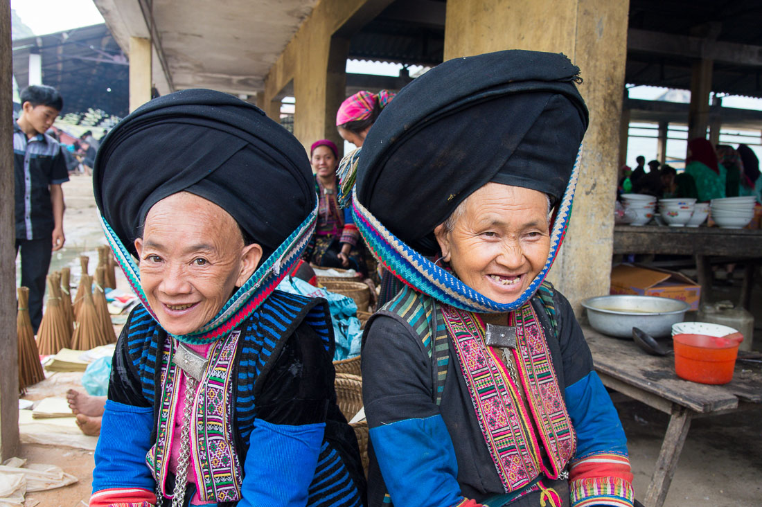 Women from the Dao people ethnic minority group, wearing turban hat and traditional clothes. Lung Phin market, Ha Gang province, Viet Nam, Indonesia, South East Asia