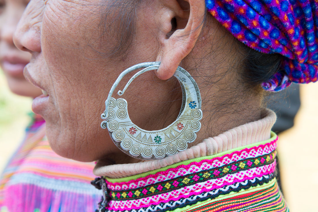 Earring of a woman from the Flower Hmong people ethnic minority group, wearing traditional clothes. Can Cau market, Lao Cai province, Viet Nam, Indonesia, South East Asia