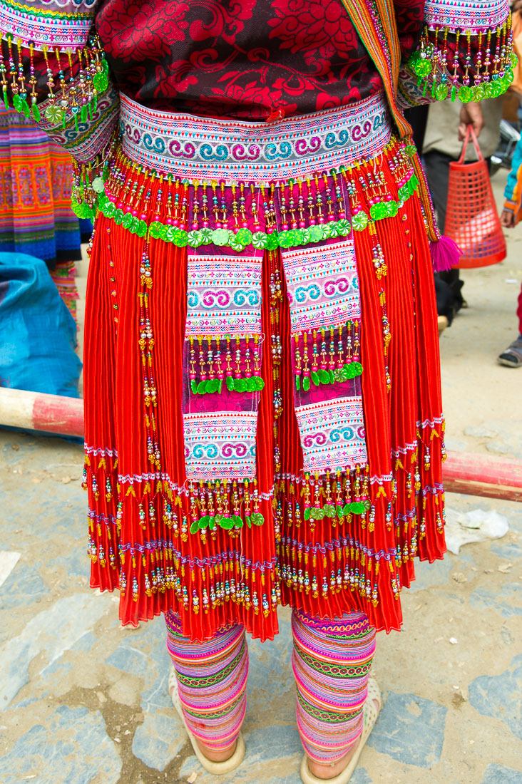 Woman from the Flower Hmong people ethnic minority wearing a colorful and beautiful traditional skirt, Bac Ha market, Lao Cai province. Viet Nam, Indochina, South East Asia.