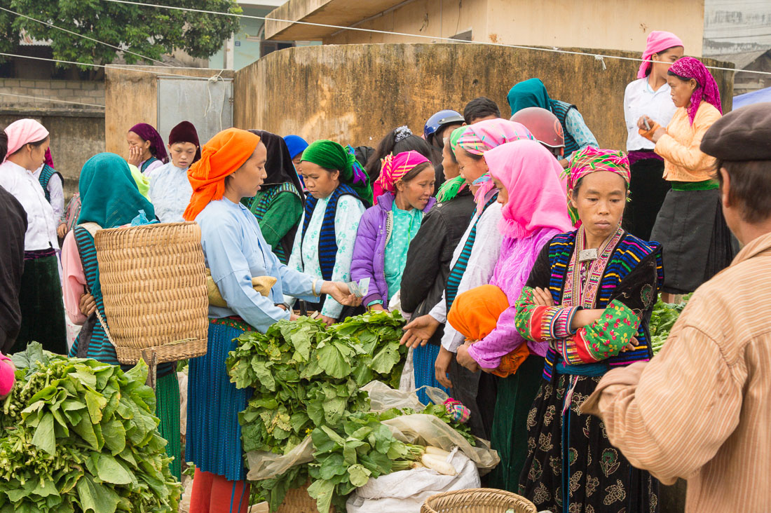 Women from the Balck Hmong people ethnic minority group, buying at busy market in Meo Vac, Ha Giang Province, Viet Nam, Indochina, South East Asia