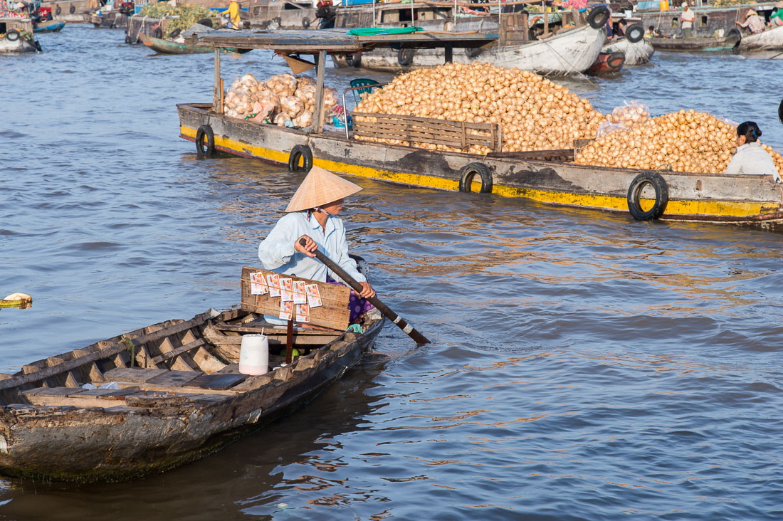 A woman selling lottery tickets at the Cai Rang vegetable floating market in the Mekong River Delta., Can Tho, Hau Giang Province, Viet Nam, Indochina, South East Asia.