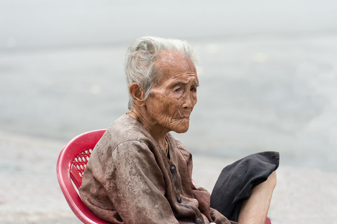 A very old man, resting on a chair in Ho Chi Minh City (Saigon). Viet Nam, Indochina, South East Asia.