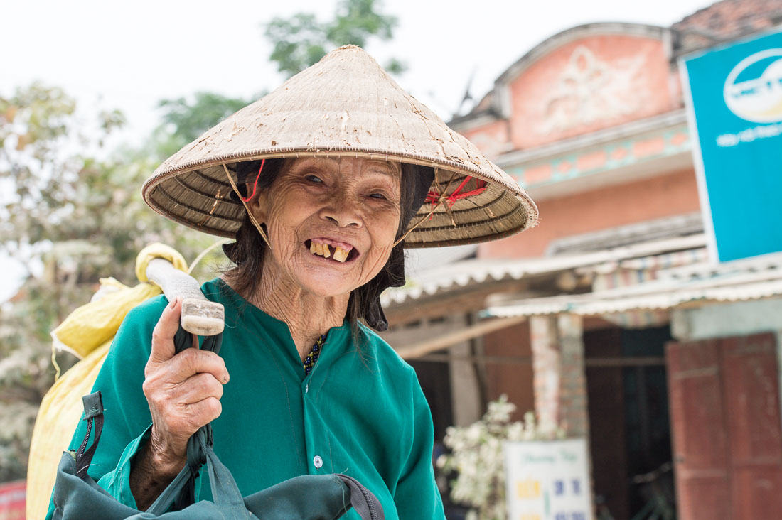 Old vietnamese woman on her way home, proudly showing her smile. Lang Son Province, Viet Nam, Indochina, South East Asia.