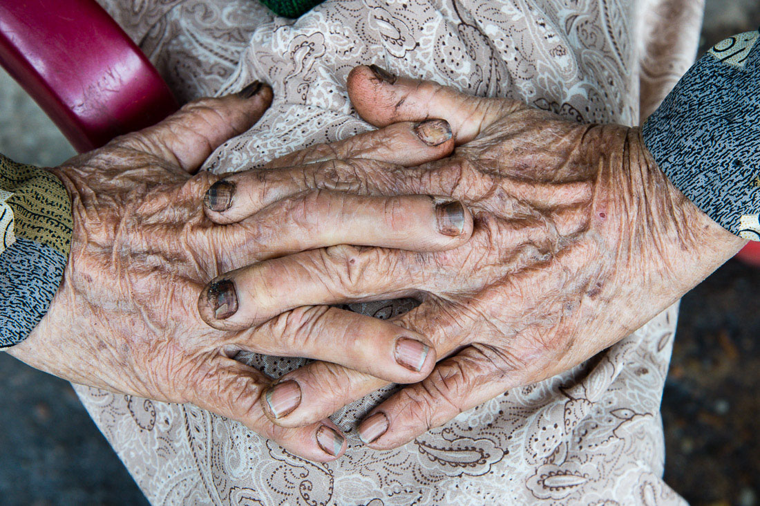 The hard working hands of an old woman at the market in Hoi An, Quang Nam Province, Viet Nam, Indochina, South East Asia.