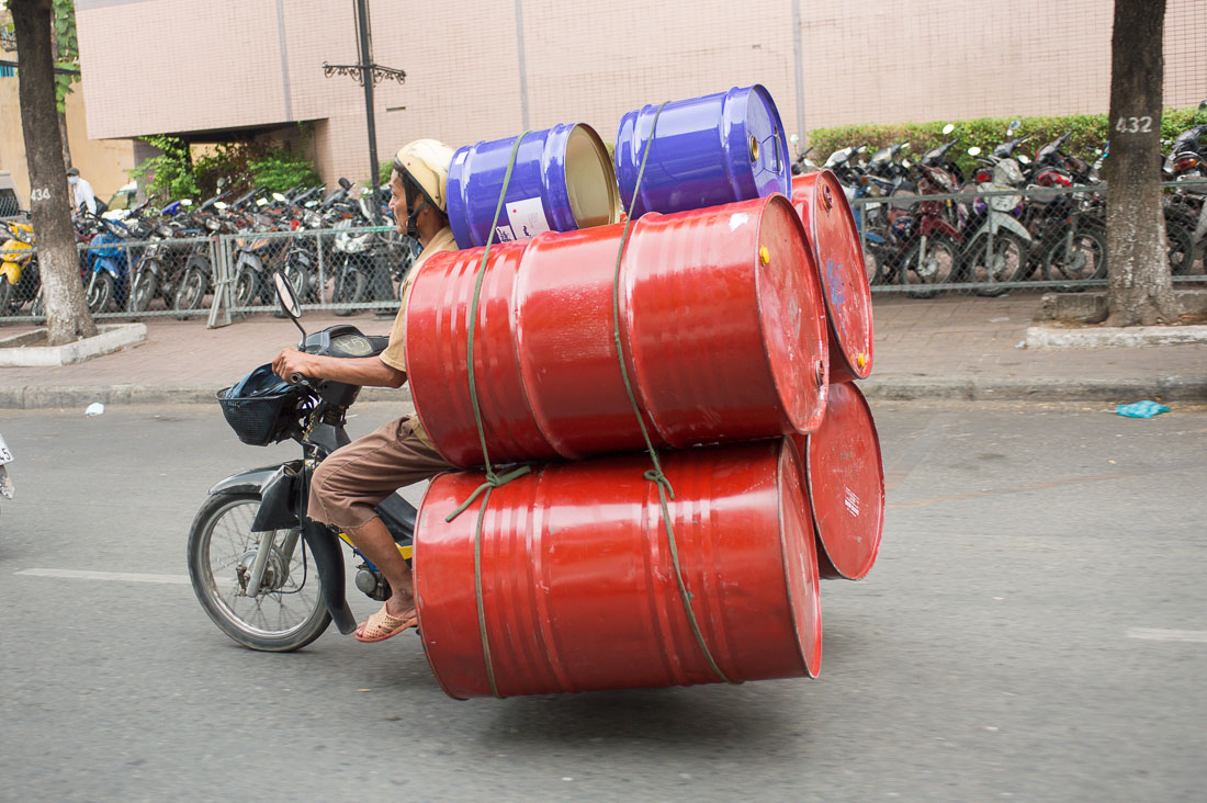 A small motorbike fully loaded with 50 gallons drums, hopefully empty! Ho Chi Minh City (Saigon), Viet Nam, Indochina, South East Asia.